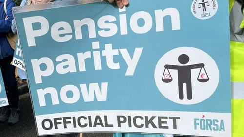 Protest sign reading “Pension parity now,” with an official picket label and restroom symbol.