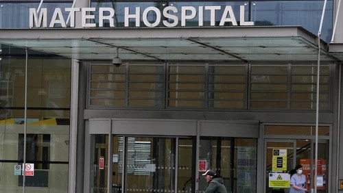 Exterior of a hospital building entrance with “MATER HOSPITAL” signage above glass doors.