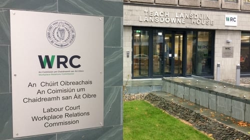 Sign reading WRC and “Labour Court” outside a building with glass doors and windows.