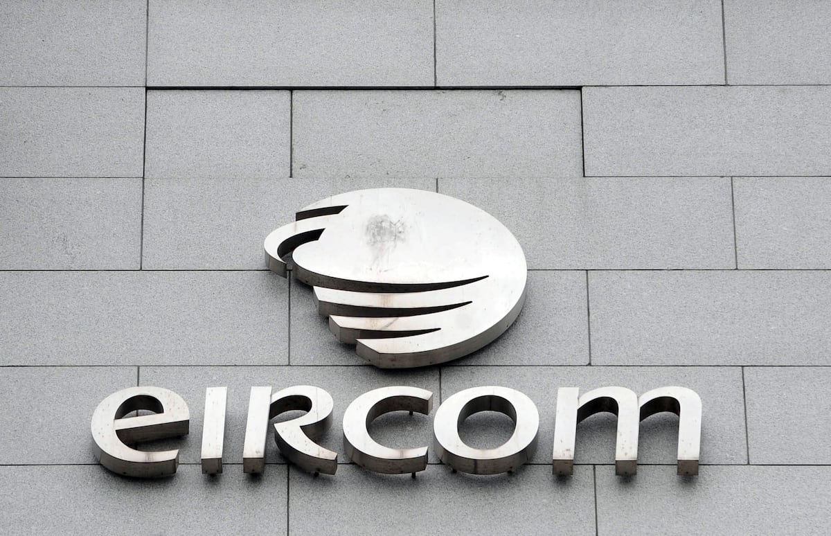White circular logo with black stripes above large “EIRCON” letters on gray stone wall.